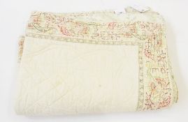 A pair quilted cushion covers, cream ground with foliate border together with a large matching