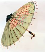 An early 20th century paper and wood parasol, painted with flowers, painted wooden handle, some wear