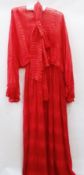 A "Hardy Amies" red silk dress, with blouson bodice with  batwing sleeves and a tie belt, fully