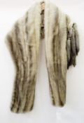 A grey mink stole with tails that can be attached