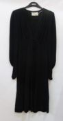 An "Ossie Clark" black crepe dress, circa 1973, with button and loop fastening to front, and to