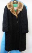 A vintage black Persian lamb coat with mink collar, labelled "Yaegers Furs, Saskatoon, Prince Albert