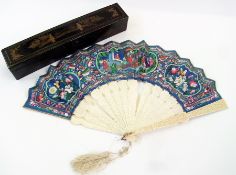 A late 19th/early 20th century Chinese Canton carved ivory and paper fan, handpainted with scrolls