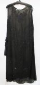 A black chiffon 1920's evening dress, heavily decorated with black and blue beads