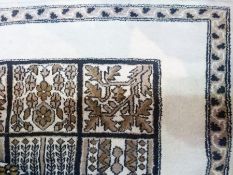 Bukhara style carpet, brown on cream ground, foliate border, central grid pattern with foliate