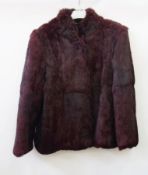 A dyed deep red vintage fur coat, possibly coney