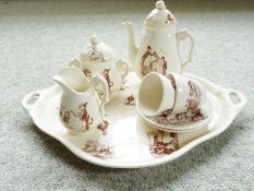 A child's early 20th century French creamware cabaret set decorated figures and animals in sepia (8)