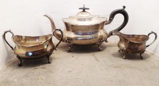 A silver three piece tea service, the squat shaped legs with paw and pad feet, Birmingham 1945, 35oz