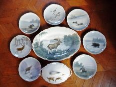 A continental part dinner service by Kaestner depicting wildlife including wild boar, hare, stags,