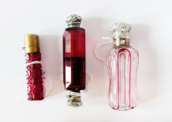 A ruby glass double-ended scent bottle, cranberry glass overlay scent bottle with silver-coloured
