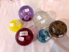 Six various glass paperweights