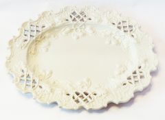 Salt glaze oval dish with relief decorated scroll trellis and hazelnut border, pear and nut