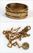 A Victorian gilt and paste bangle, set five stones and a gold- coloured locket and chain (2)