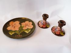 Pair Moorcroft squat candlestick holders, in brown and a Moorcroft plate, dated 1986 signed to base,