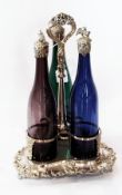 Victorian silver-plated three-bottle decanter stand, trefoil pattern, with three coloured glass