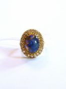 18K gold, black opal and diamond dress ring, set large oval cabochon opal surrounded by claw set