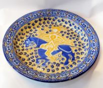 A large Spanish/Portuguese faience charger depicting a mounted huntsman with a lance (af),