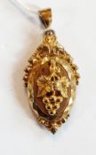Victorian gold-coloured metal locket, shaped oval applied with bunch of grapes ornate border with