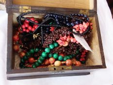 A quantity of costume jewellery to include necklaces, beads, brooches, lady's watches, etc. (1 box)