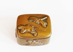 Circa 1900 Japanese patinated brass pillbox with relief decoration of dragonfly, frog, and other