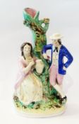 19th century Staffordshire pottery flatback figure group spill vase, depicting man and woman resting