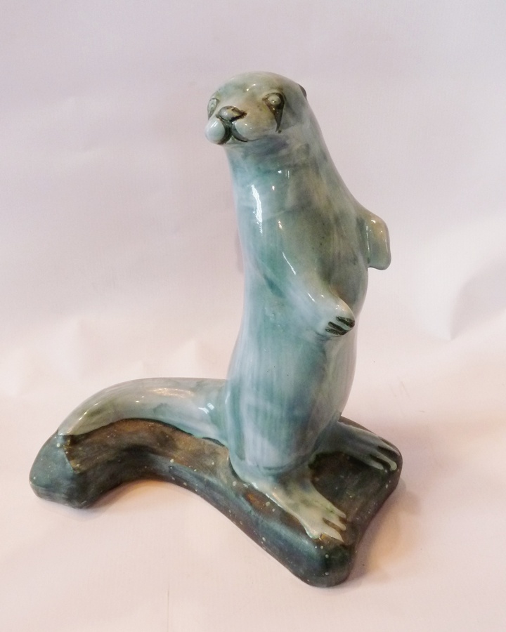 Rye Pottery otter by David Sharp, in blue on dark green base, mark to base, 30cm high