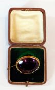 9ct gold brooch, set with amethyst-coloured stone, circular with ropetwist decoration (in box)