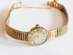 A lady's Omega 9ct gold wristwatch, with silver dial and matching link bracelet