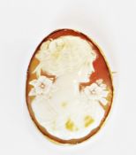 Carved shell cameo brooch/pendant, head and shoulders profile portrait of a young woman in floral