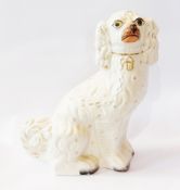 19th century Staffordshire pottery spaniel, with orange nose, painted eyes, gilt collar and chain,