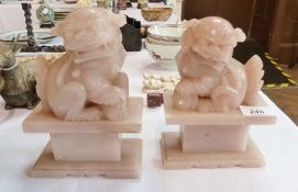 Pair Chinese carved pink soapstone temple dogs on engraved block bases, 19cm high and a green