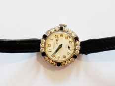 Lady's Swiss platinum, diamond and black onyx cocktail wristwatch with circular dial and Arabic