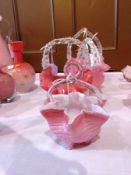 Pink and white striped basket with clear handle and three other Victorian pink and clear baskets