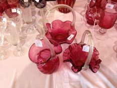 Three cranberry and clear glass baskets