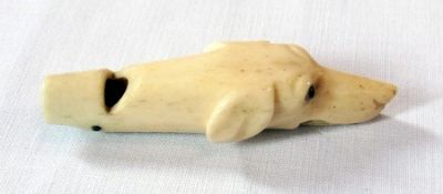 A Victorian carved ivory novelty whistle in the form of a dog's head, with inset eyes