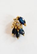 A sapphire and diamond pendant, stylised floral shape
