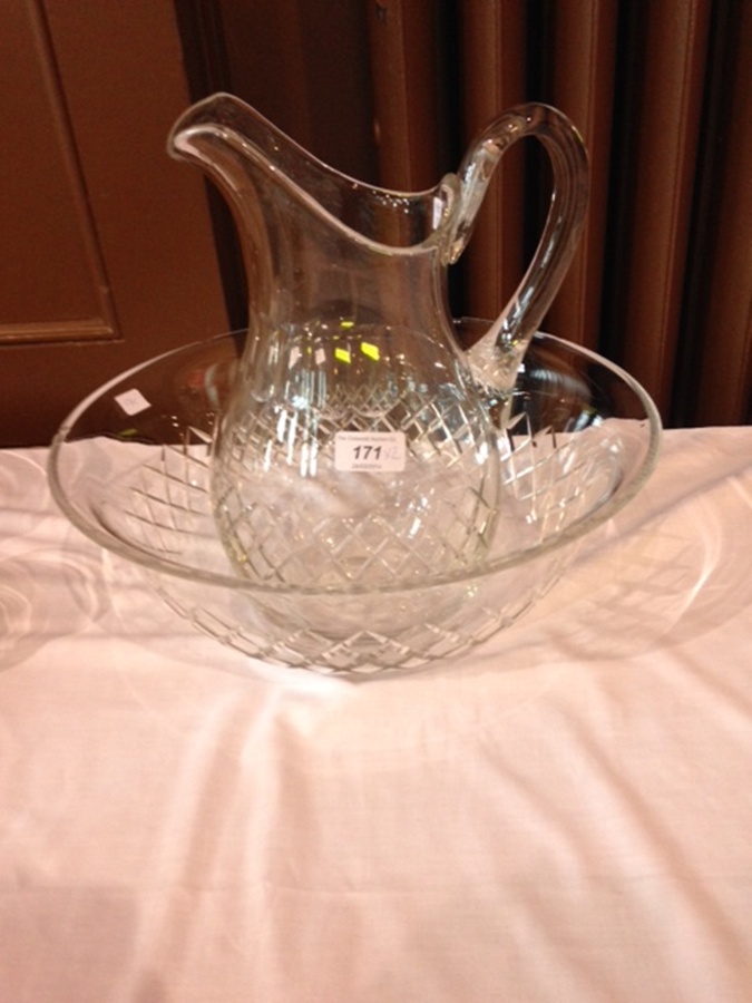 Late Victorian/Edwardian cut glass ewer and basin, the baluster-shaped ewer panel and trellis cut