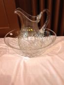 Late Victorian/Edwardian cut glass ewer and basin, the baluster-shaped ewer panel and trellis cut