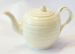 18th century small creamware teapot, the lid with flowerhead finial, having double twisted scroll