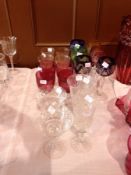 Set of six cut and flash-coloured glass hocks with cut panelled stems, various cranberry and other