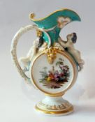Berlin RPM porcelain cabinet jug decorated with putti figures on handle, grape relief decoration and