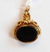 Gold-coloured metal bloodstone and cornelian revolving fob, oval on ornate scroll and bead mount