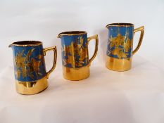 Set of three graduated Saddler's jugs, blue ground with gilt decoration, largest is 17cm high (3)