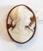 Gold-coloured metal cameo brooch set oval shell carved with head and shoulders of girl and bird