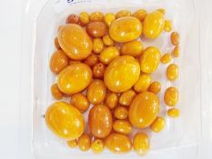 A quantity of unstrung amber yellow beads of different sizes (1 box)