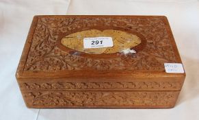 A carved oriental sandalwood rectangular box, with floral decoration, enclosing a Victorian turned