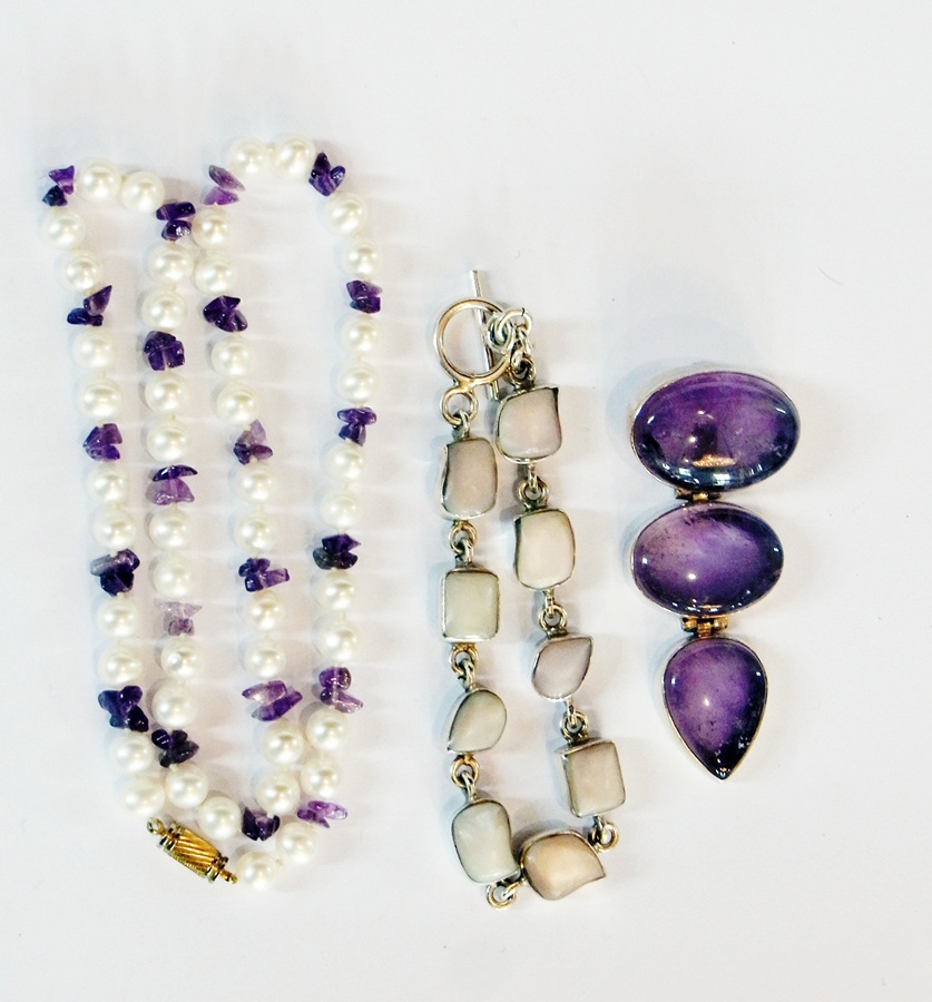 Three graduated stone amethyst and silver drop pendant, silver and shell bracelet and a pearl