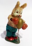 A clockwork model of a boxing rabbit, with tinplate face and base, height 17cm