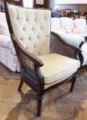 Modern dark stained wood button back and caned armchair upholstered in pale green dralon, caned arms