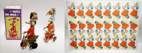 German tinplate clockwork "Duck on Bike" boxed, Chinese tinplate "Duck on Bike", copy and a sheet of